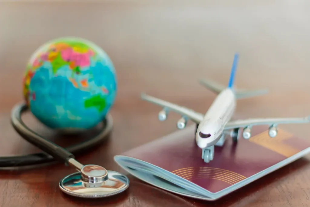 Avião, passaporte, globo terrestre e estetoscópio simbolizam a necessidade de seguro internacional em viagens para Ushuaia.