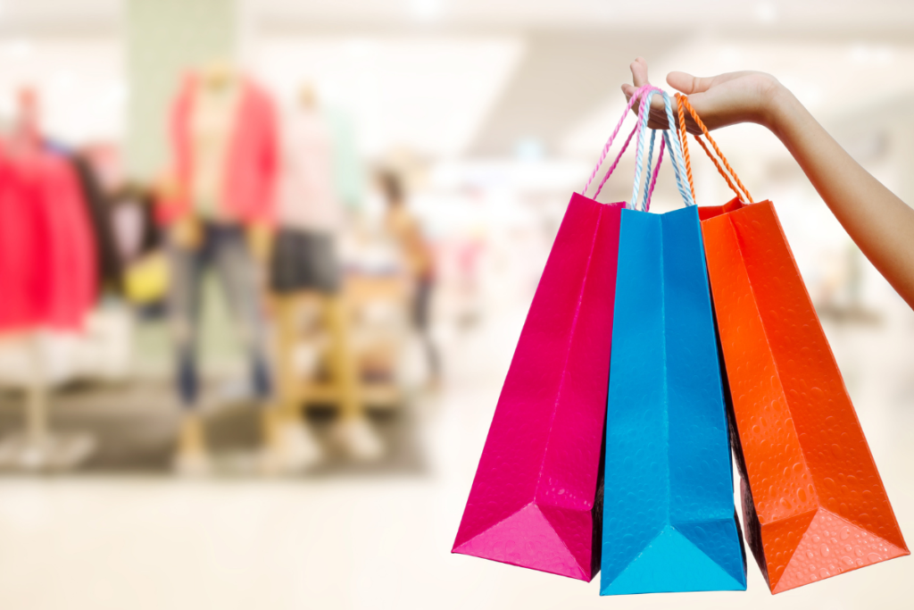 Sacolas de compras coloridas em frente a lojas de shopping no Chile, destacando oportunidades de consumo em 2026.