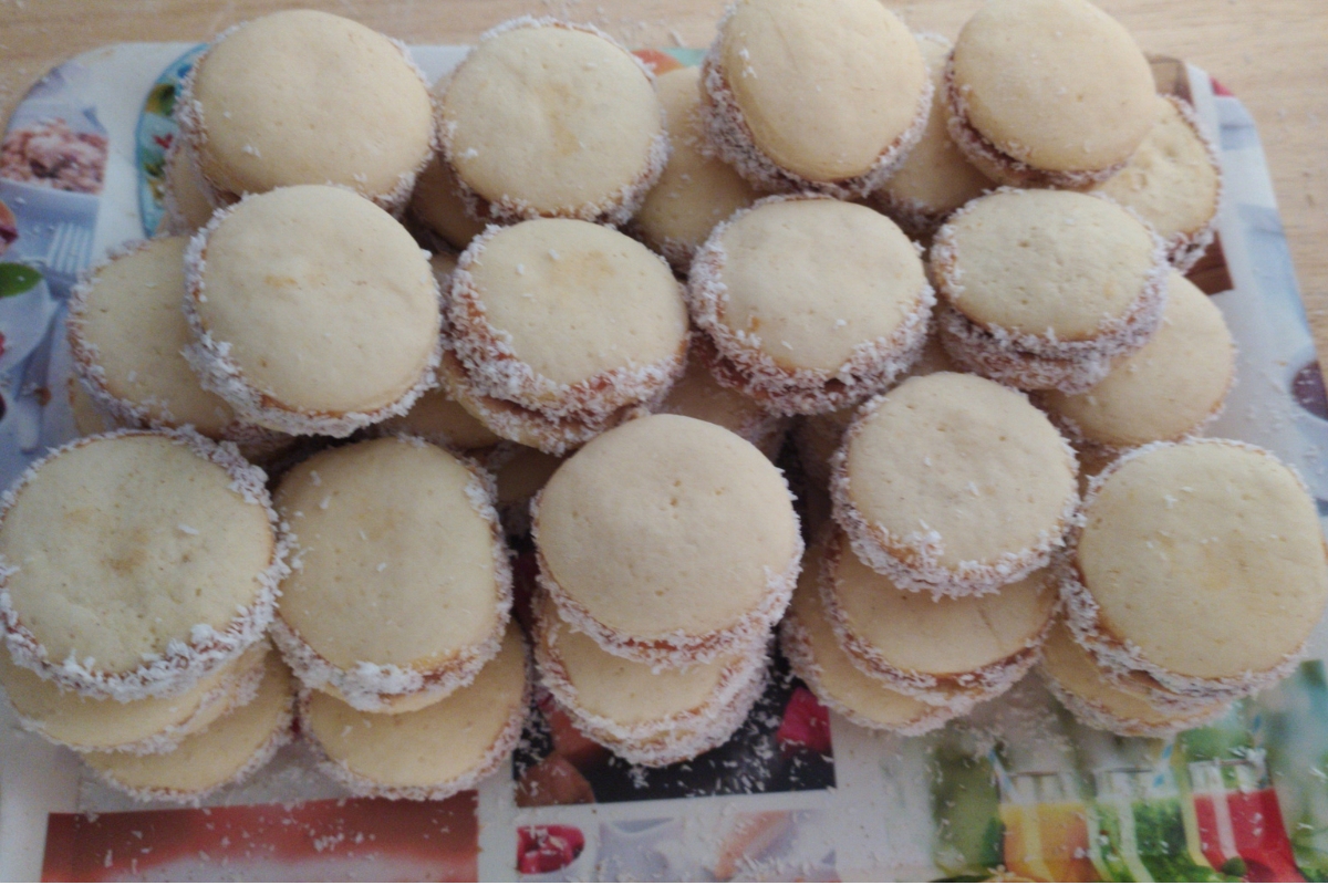 Alfajores de maicena recheados com doce de leite e finalizados com coco