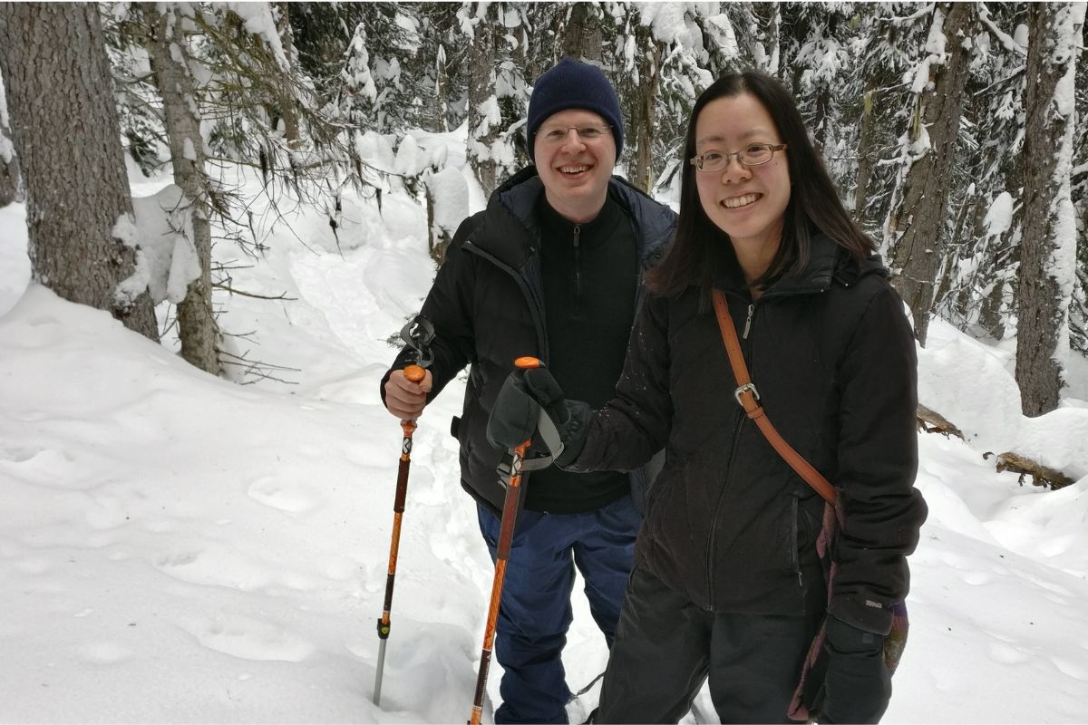 Viajante caminhando com raquetes em uma paisagem coberta de neve