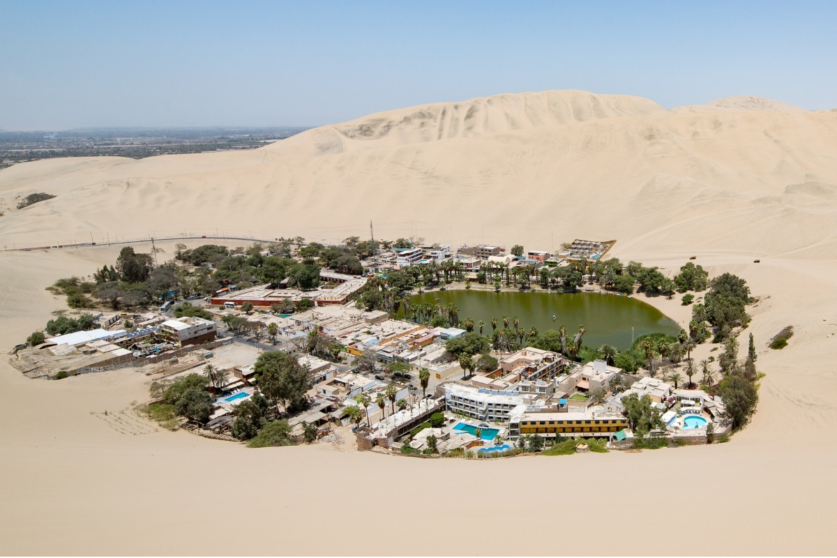 Vista panorâmica do oásis de Huacachina cercado por dunas, no Peru.